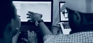 Developers looking at computer screen